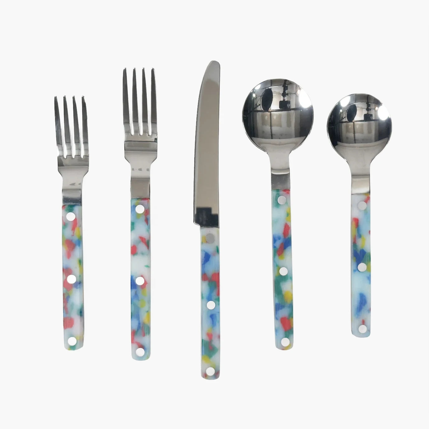 Utensils Set - Slowdown Studio. Set of cutlery with colorful handle designs on a white background