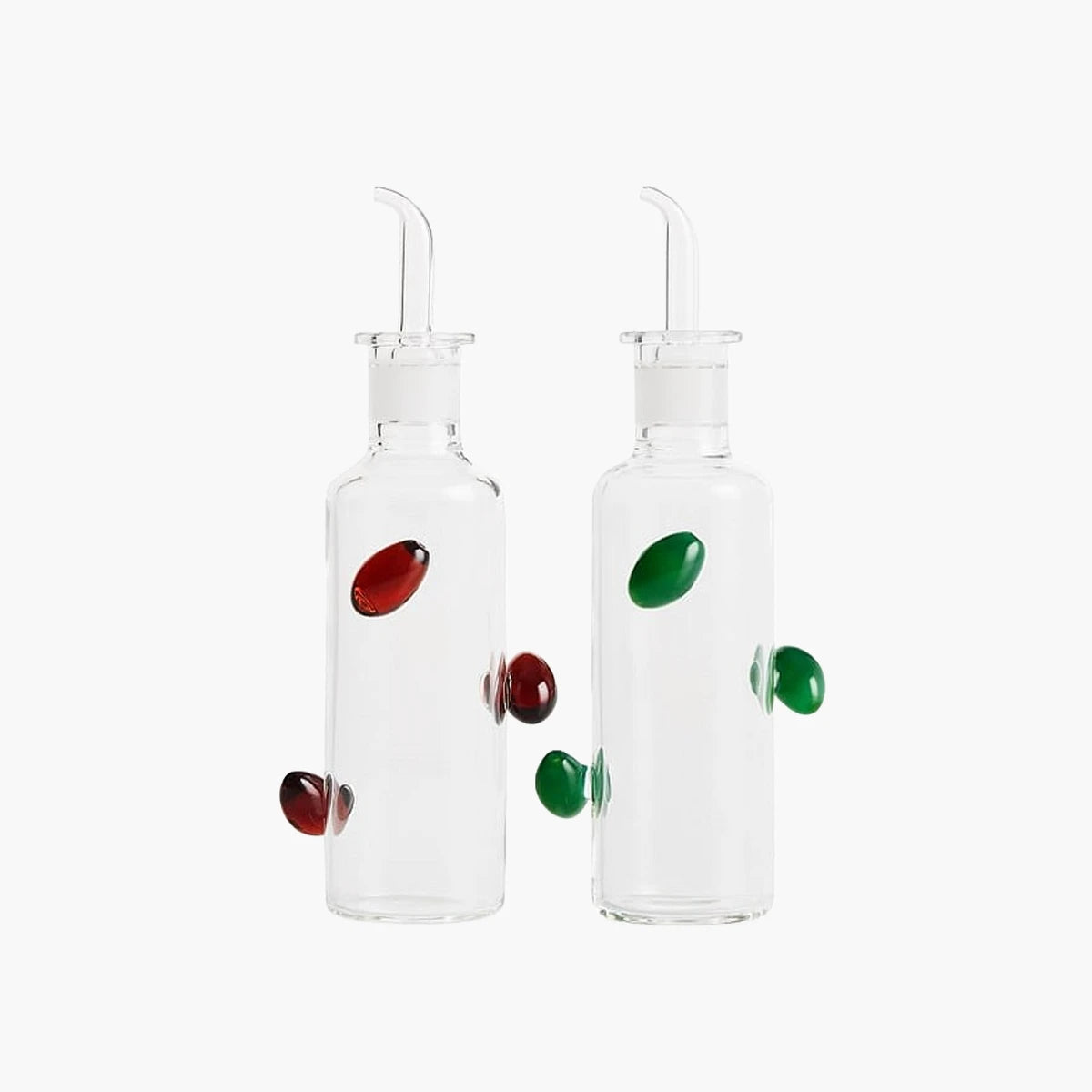 Two clear glass bottles with colorful knobs on a white background