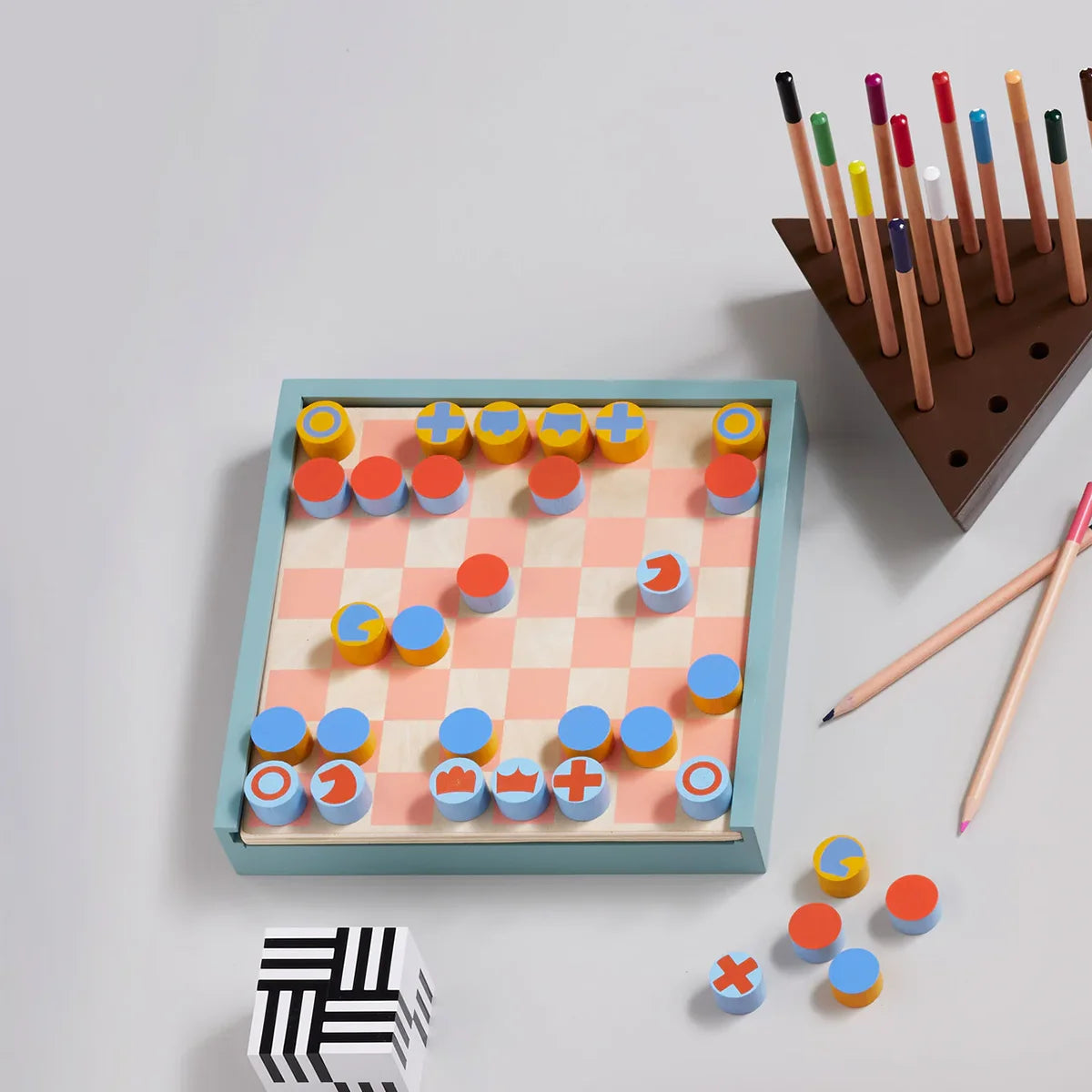 Board game with colorful pieces and a stand on a light gray background