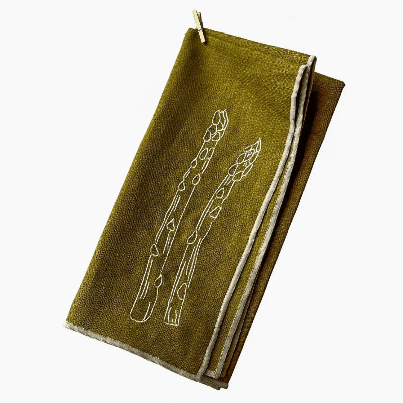 Green napkin with white asparagus design on a white background