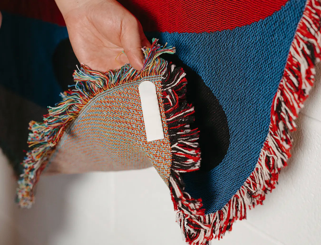Double-sided tape attached to the bottom back of the woven blanket.