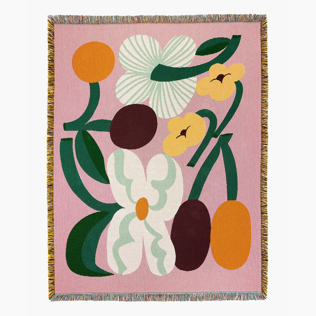 Slowdown Studio Cooper woven throw blanket with a pink background and a retro floral pattern in orange, yellow, white, and dark green. The blanket features fringed edges on all sides.