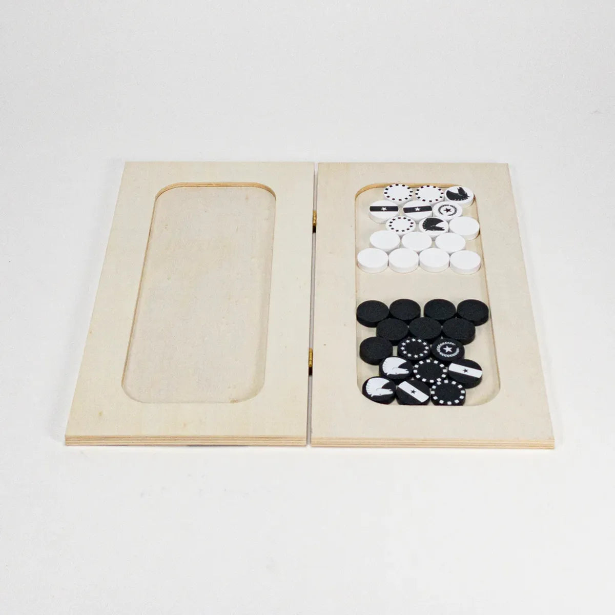 Wooden chess with black and white pieces on a light gray background