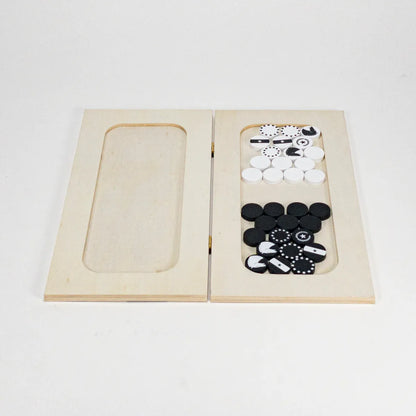 Wooden chess with black and white pieces on a light gray background