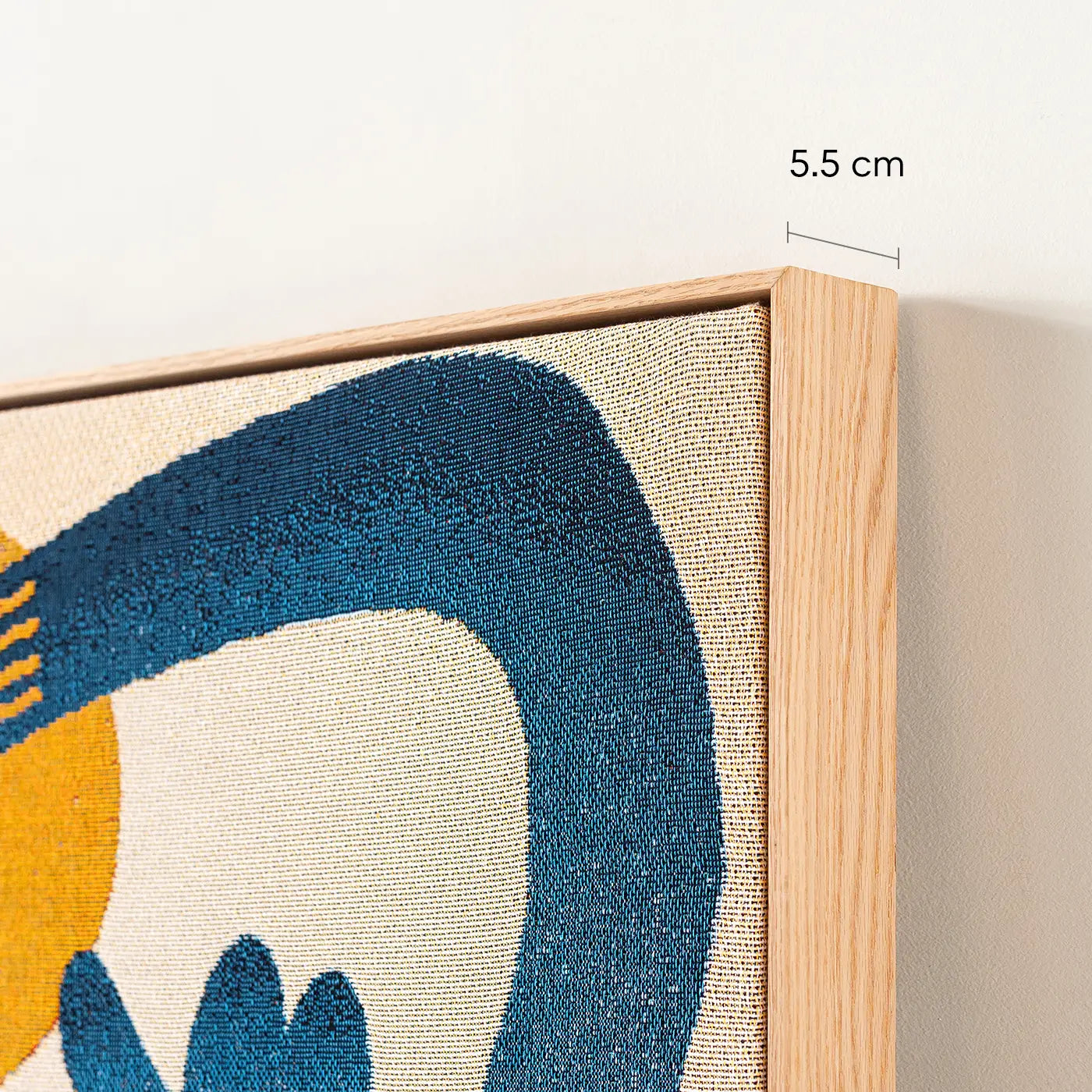 Woven throw stretched and framed with an oak timber frame, showing a close-up of the edge and side profile measuring 5.5cm