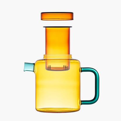 Orange glass teapot with a teal handle and spout on a white background