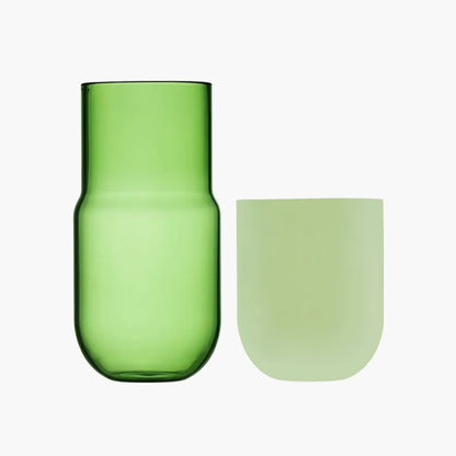 Green glass carafe and cup on a white background