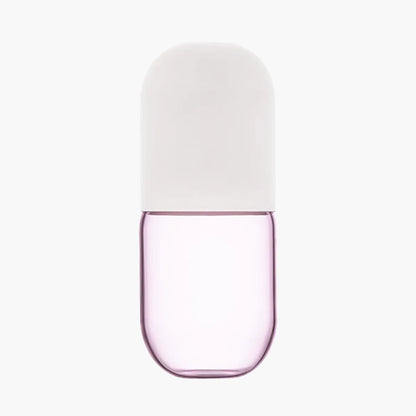 Pink glass carafe with a white lid on a white background