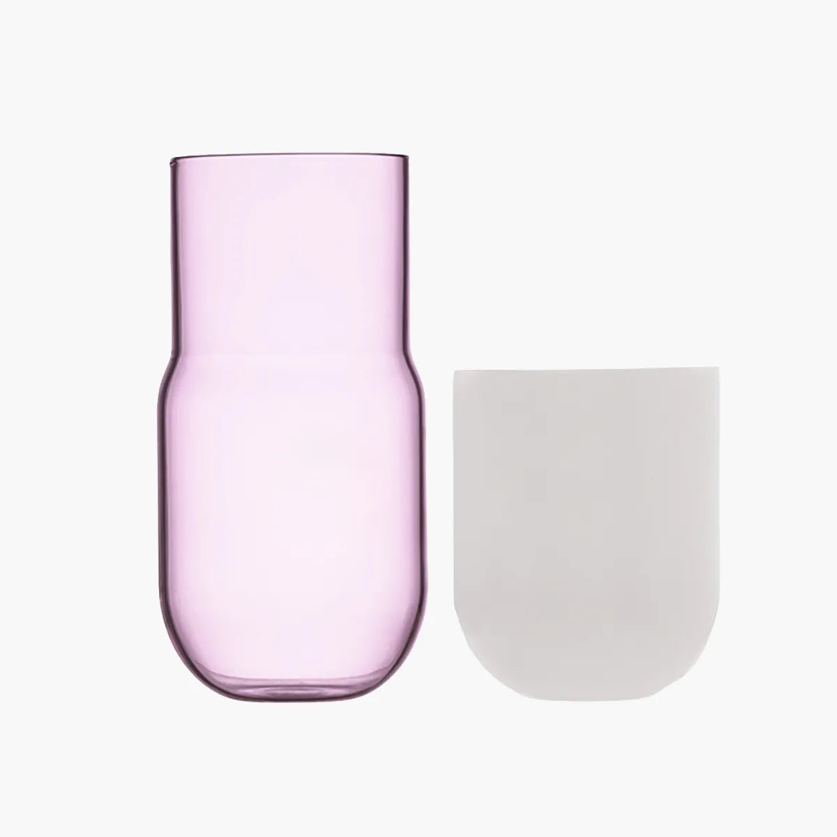 Pink glass tumbler and white cup on a white background