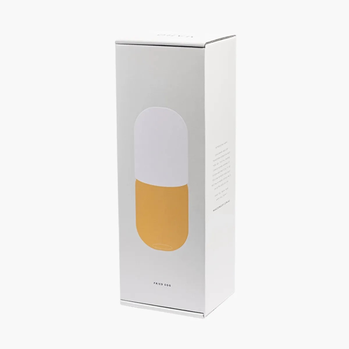 Product packaging with yellow carafe and white cup set inside on a white background