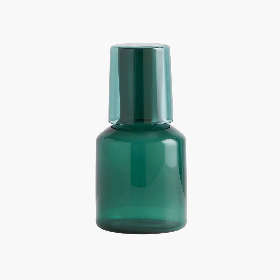Green carafe and glass set on a white background