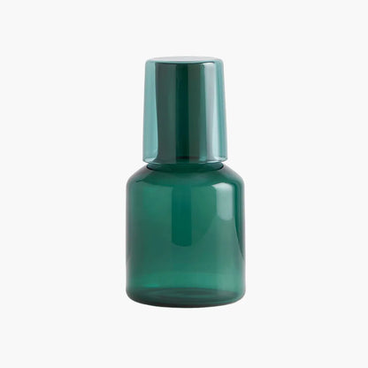 Green carafe and glass set on a white background