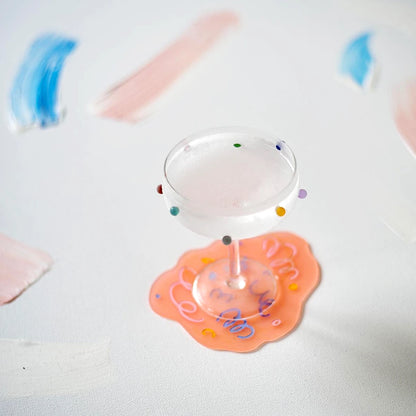 Two cocktail coupe glasses with colorful dot patterns by Maison Balzac