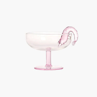 Pink prawn cocktail glass with a pink prawn decoration on a white background