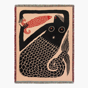 Woven blanket with a black mermaid folk art design on a beige background