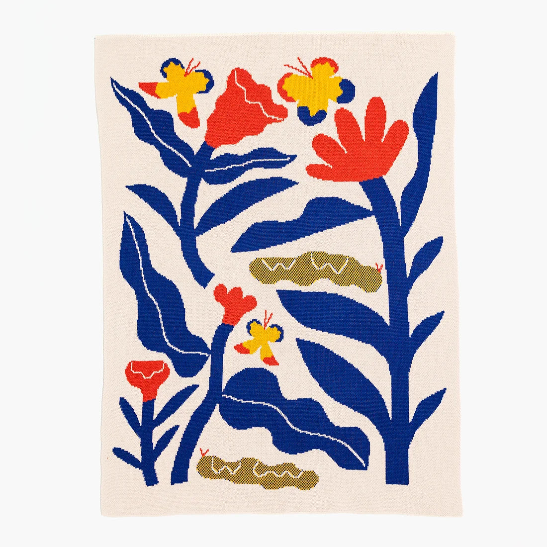 Decorative baby blanket with colorful floral and butterfly design on a beige background