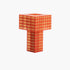A Ridezign Tesser 5:8 Lamp made of translucent orange-red acrylic grid cubes, shown on a plain light gray background.