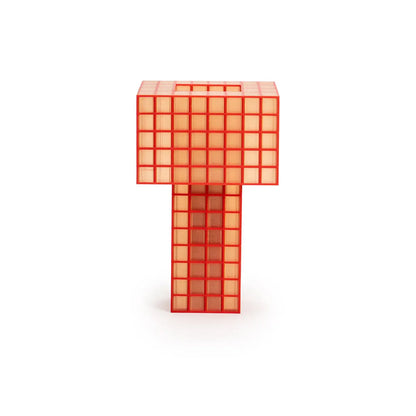 A translucent orange-red Ridezign Tesser 5:8 Lamp, featuring a grid pattern and a square top, displayed on a clean white background.