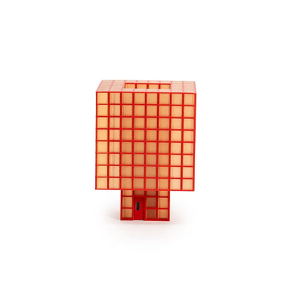 A translucent orange-red Ridezign Tesser 8:3 Lamp with a grid pattern, standing upright on a small matching base against a plain white background.