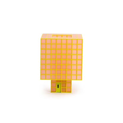 A translucent orange and yellow cube-shaped Ridezign Tesser 8:3 Lamp with a small green door detail, shown on a plain white background.