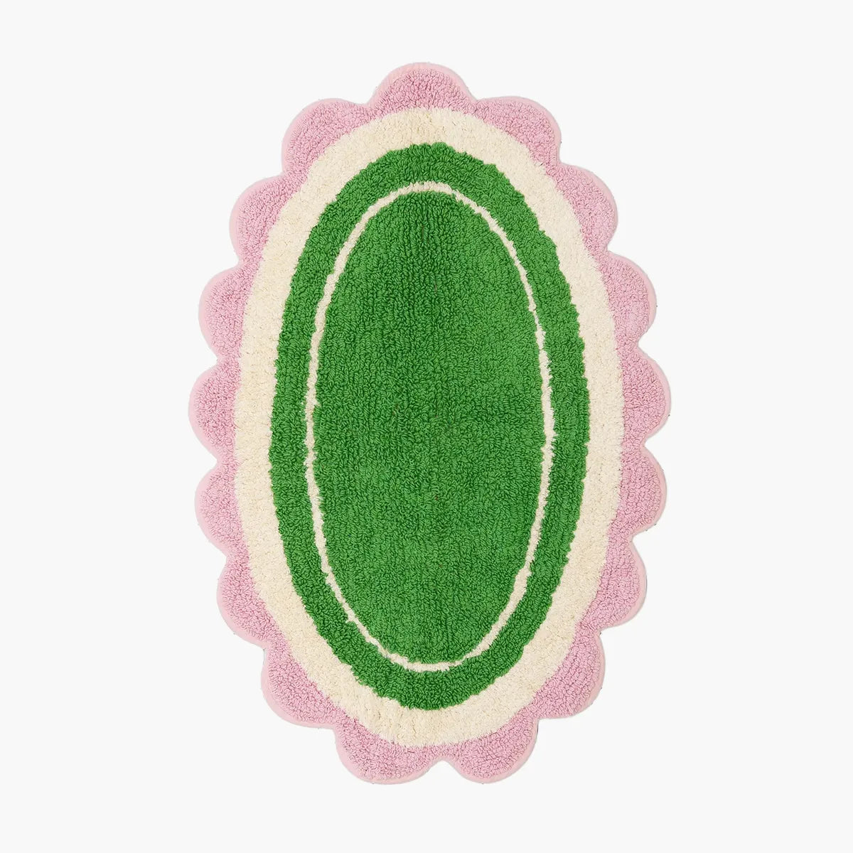 Green oval rug with pink scalloped edge on a white background