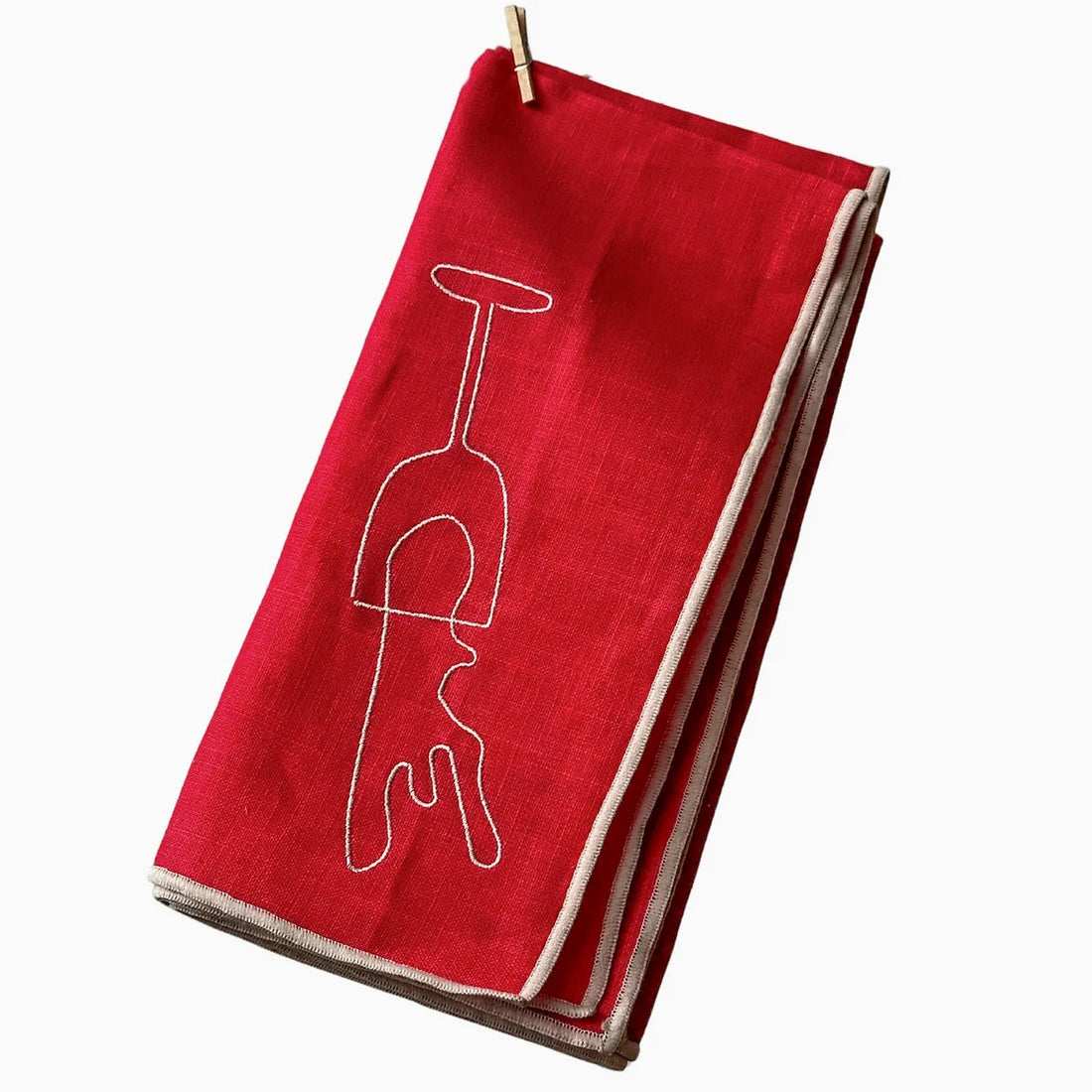 Red napkin with a white wine glass design on a white background