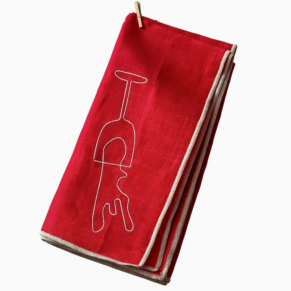 Red napkin with a white wine glass design on a white background