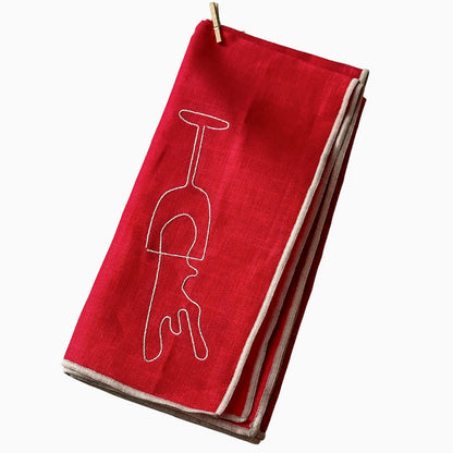Red napkin with a white wine glass design on a white background