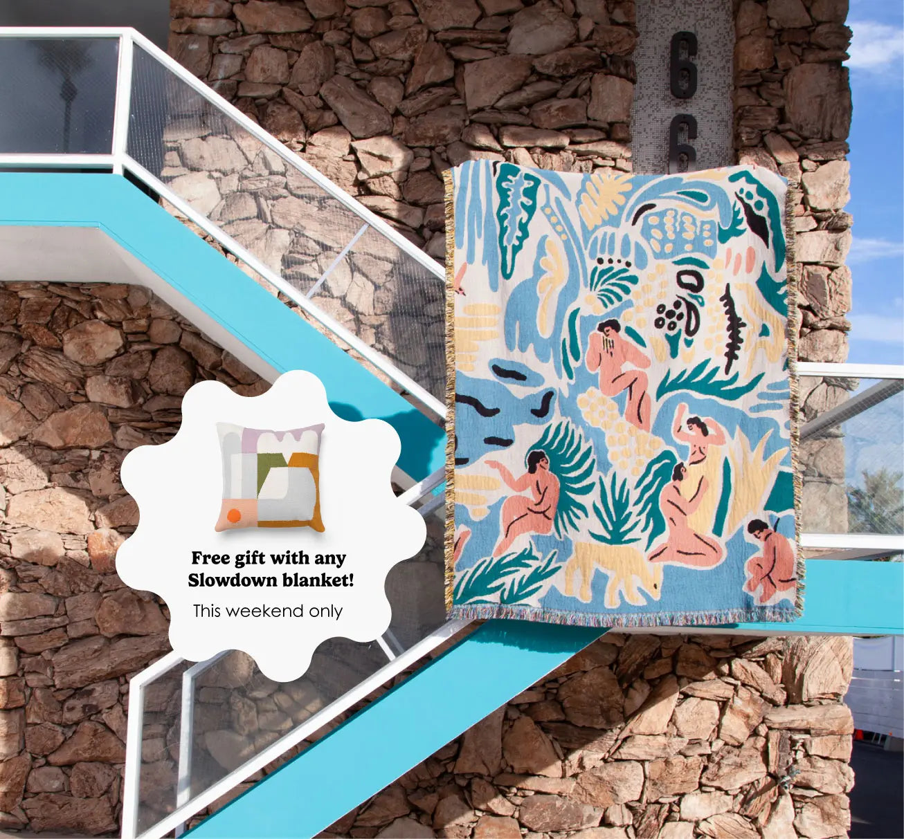 Colorful blanket with artistic design on a stone wall background